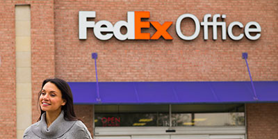Woman leaving a FedEx Office location