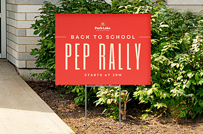 red pep rally yard sign in school front lawn outside front school entrance