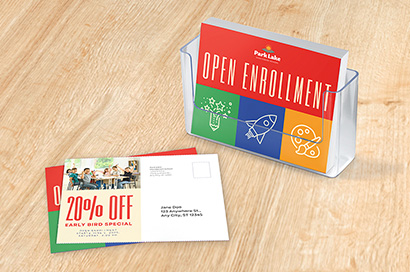 A stack of printed direct mail postcards for a promotion for open enrollment at a school