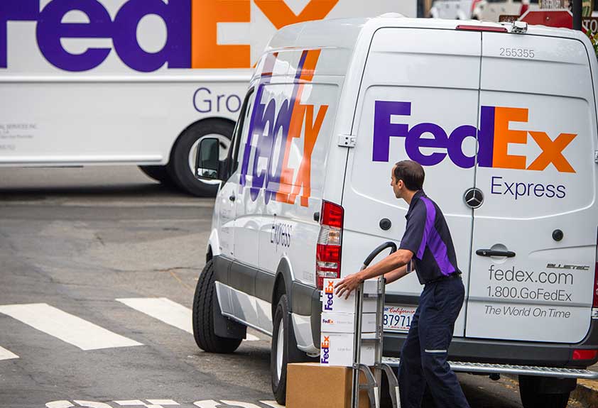 FedEx Office truck on road in en route to customer delivery destination