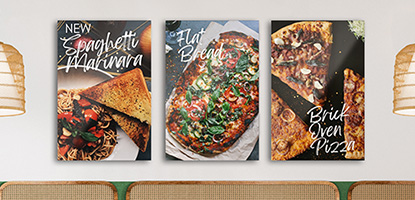 Pizza imagery printed on photo posters hanging on a wall