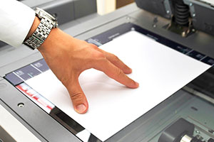 A customer scanning a document at a FedEx Office location